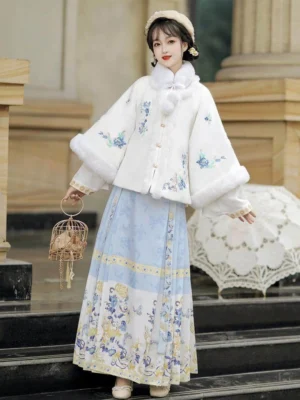 White Ming Dynasty Hanfu embroidered fleece square collar jacket with blue floral embroidery and porcelain print mamian skirt on a marble staircase