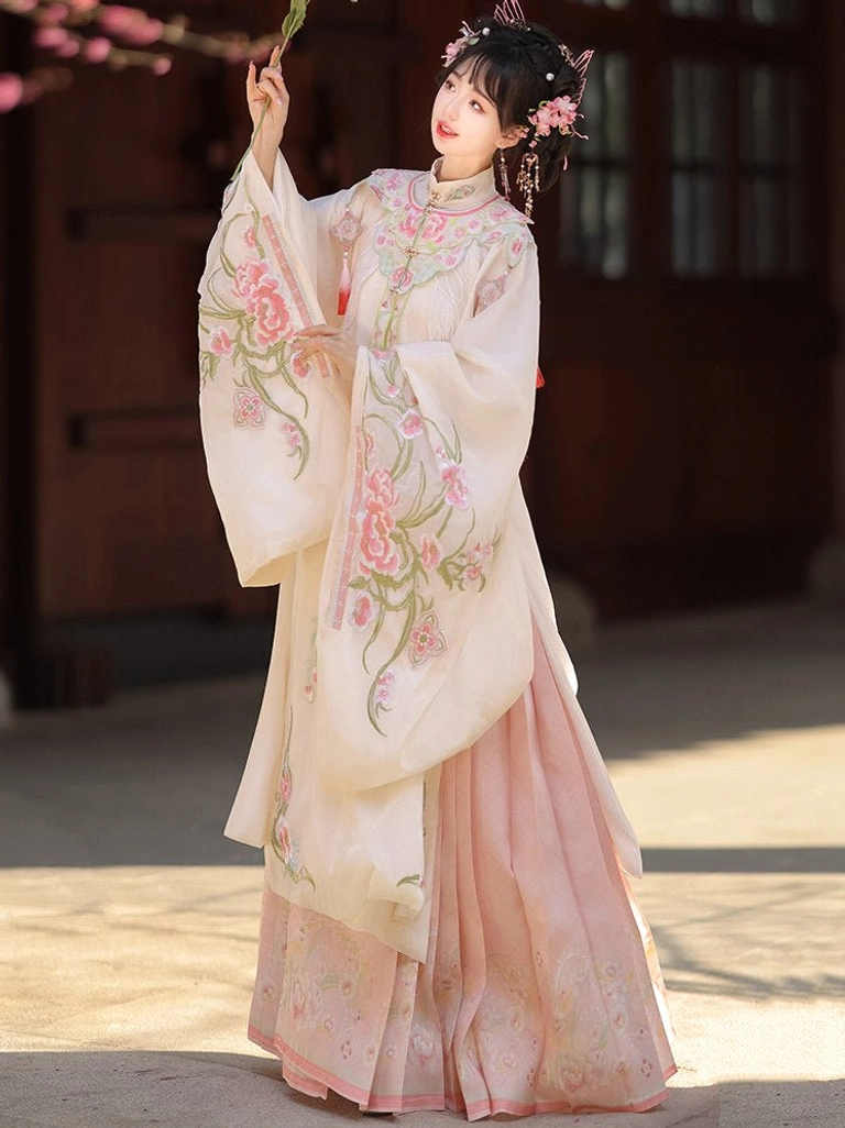 Full length side view of embroidered Ming Dynasty Hanfu robe with wide sleeves and high waisted pink pleated mamianqun skirt