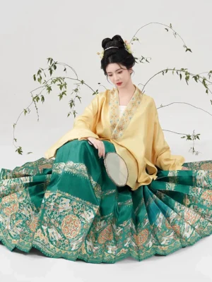 Ming Dynasty Hanfu yellow pipa sleeve top paired with green mamianqun skirt featuring lucky rabbit and floral jacquard hem
