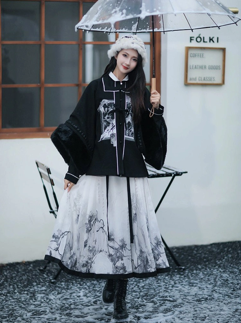 Full-body view of a Ming Dynasty inspired modern hanfu outfit with black stand-collar top, white ink landscape mamianqun horse face skirt, and autumn scenery styling in a snowy courtyard