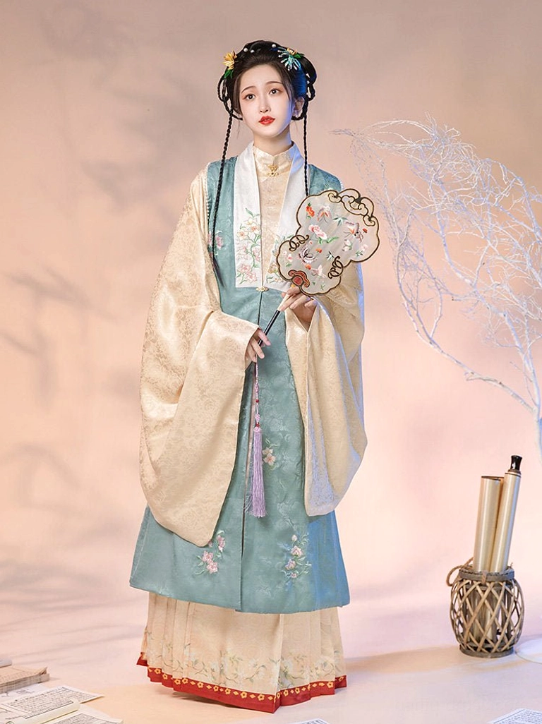Ming Dynasty inspired Chinese hanfu set with teal floral embroidered vest beige robe pink skirt and red tassel detail
