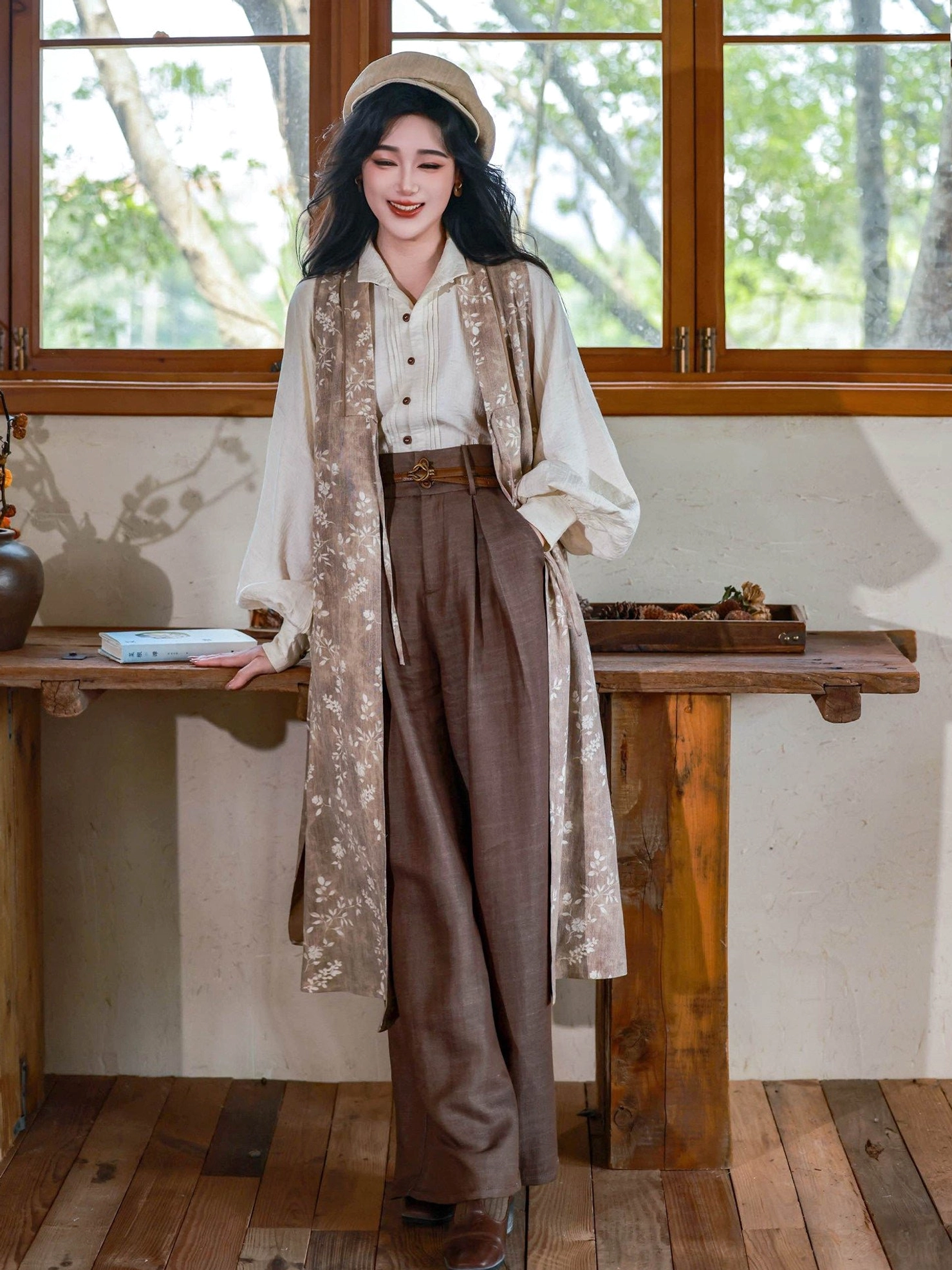 Full front view of a three-piece Ming Dynasty inspired hanfu outfit with off-white stand-up collar top, dark floral long robe, and high-waisted brown wide leg pants