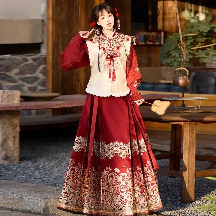 Full styling view of Ming Dynasty inspired modern Hanfu set with clean silhouette, wine red embroidered mamianqun skirt, cream vest, cloud collar, and traditional red hair accessories