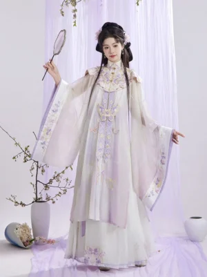 Full-body front view of a woman wearing a lavender and ivory Ming Dynasty embroidered Hanfu set with butterfly floral embroidery, wide sleeves, cloud collar, Mamianqun skirt, traditional Chinese hairstyle, and round silk fan
