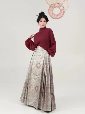 Red knit sweater and Ming Dynasty inspired mamian skirt outfit worn by model in a full length studio view