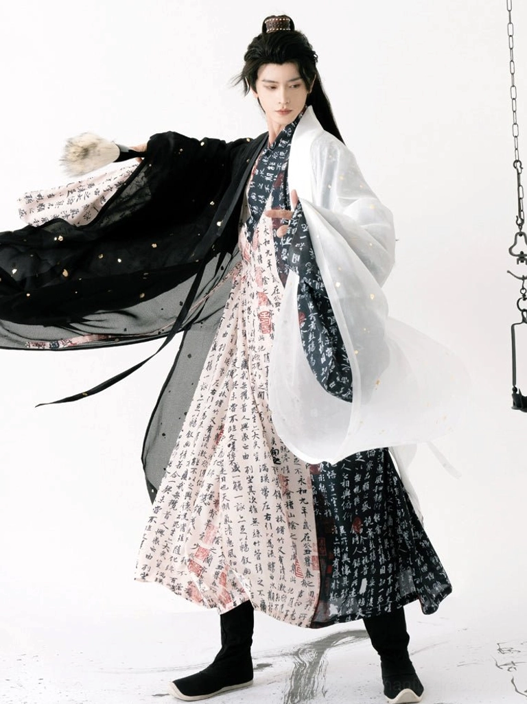 Ming Dynasty inspired men's calligraphy hanfu robe in black and ivory with flowing sleeves and gold fleck accents, shown in a three-quarter full-body view