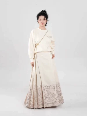 Full-body front view of a modern Ming Dynasty Hanfu mamianqun skirt with off-white gradient fabric and lotus embroidery styled with a contemporary top