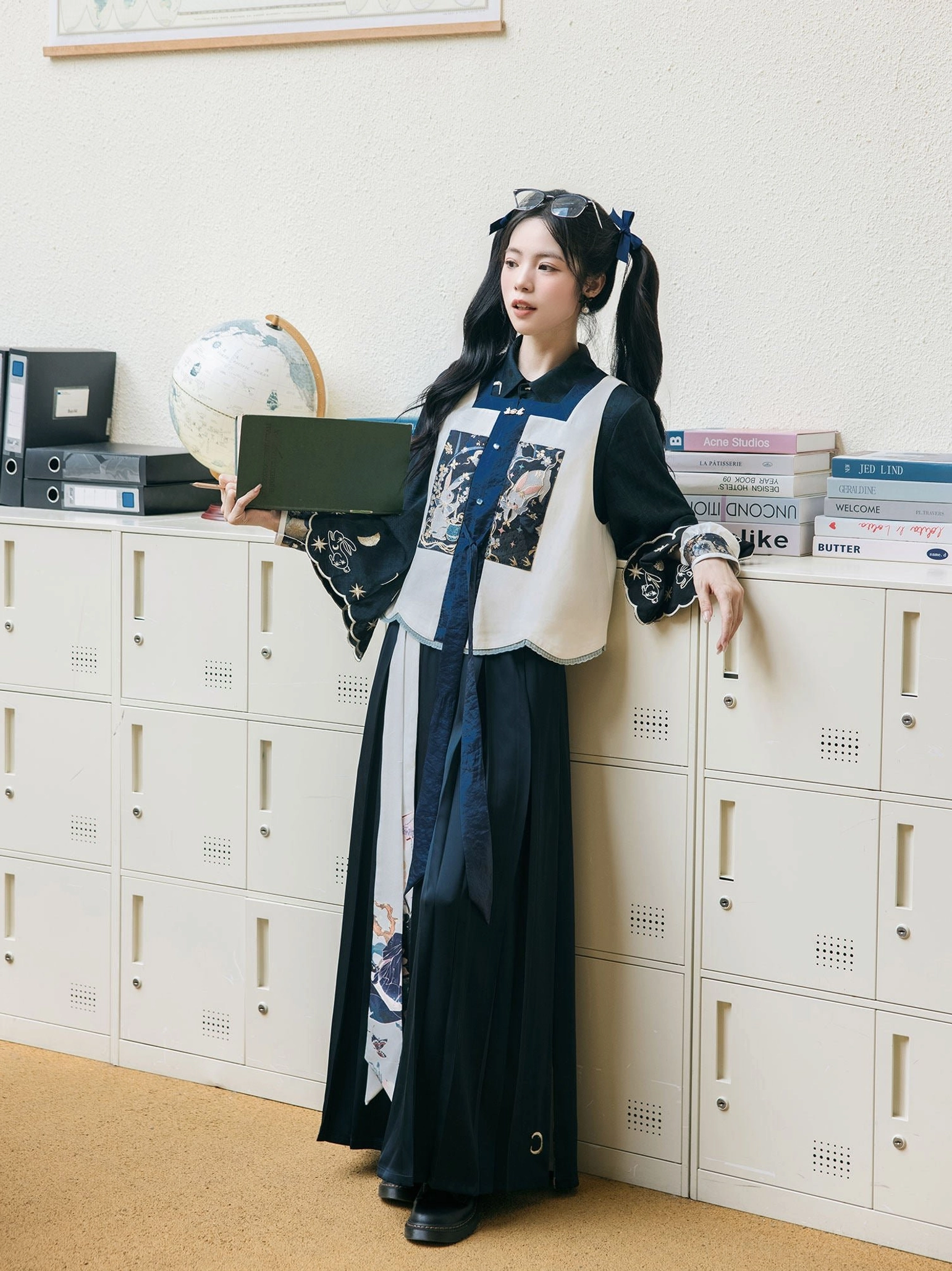 Full-body side view of a woman wearing a Ming Dynasty inspired modern Hanfu outfit with dark navy wide-leg pants, contrasting bijia vest, long-sleeve blouse, and moon palace osmanthus laurel motifs