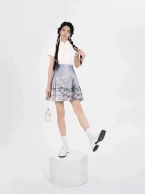 Front view of a Ming Dynasty inspired modern Hanfu set with an off-white mandarin collar top and light-blue landscape print mini mamianqun skirt