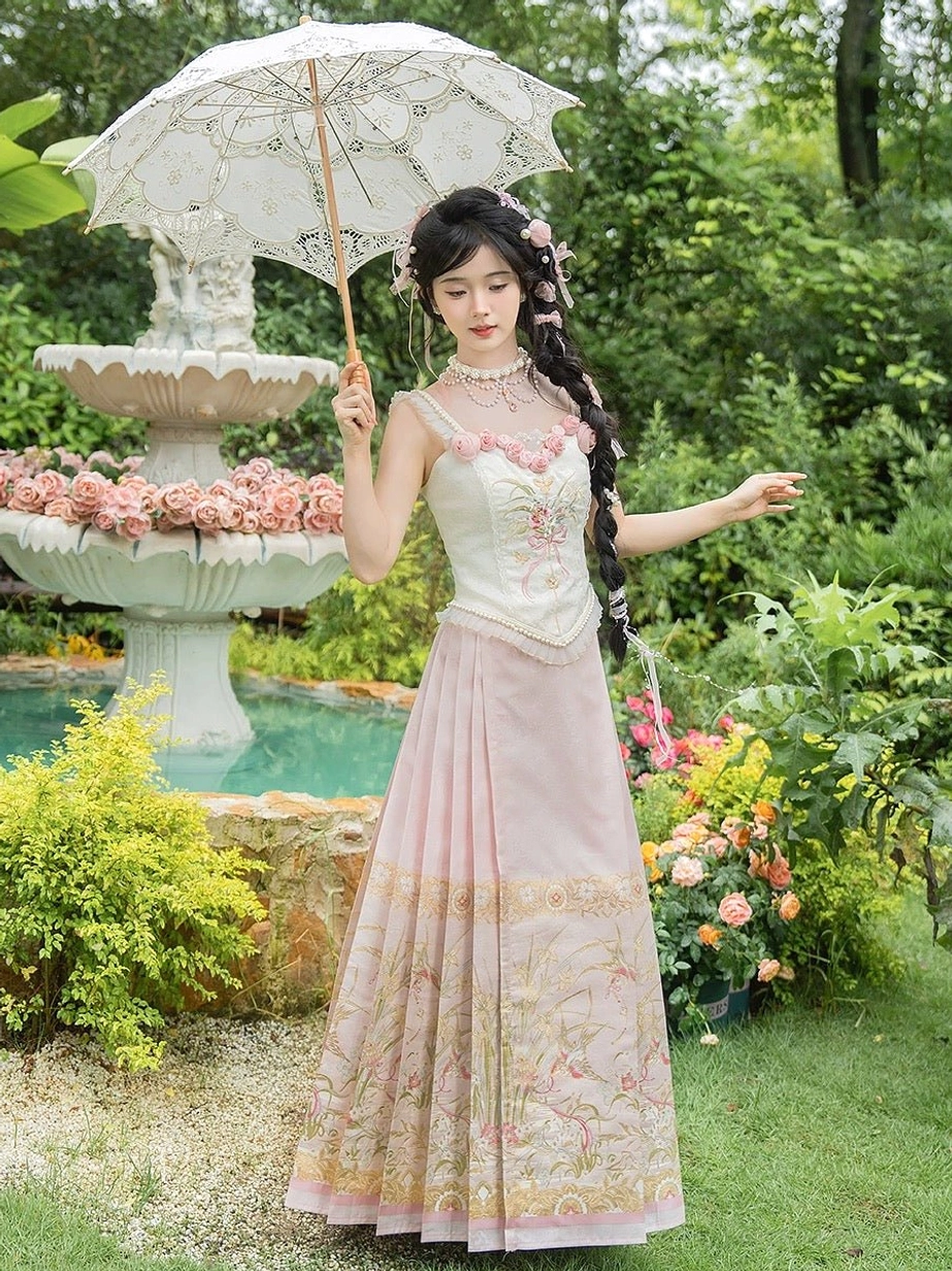 Ming Dynasty inspired modern Hanfu Waltz complete set worn by a woman in a garden, featuring a cream floral bustier, pink embroidered mamian horse face skirt, three dimensional roses, and gold trim
