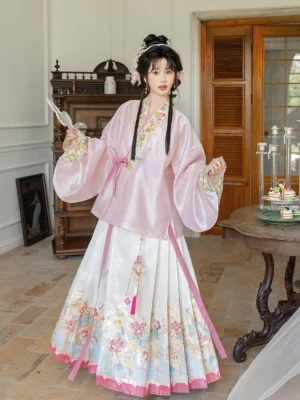 Three-quarter view of women’s pink Ming Dynasty Hanfu with floral embroidered mamian skirt and traditional cross-collar top