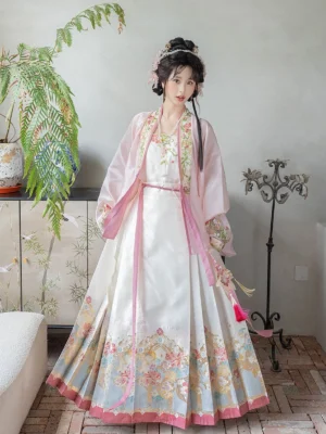 Women wearing Ming Dynasty pink Hanfu set with cross-collar top and ivory embroidered mamian skirt in a vintage interior