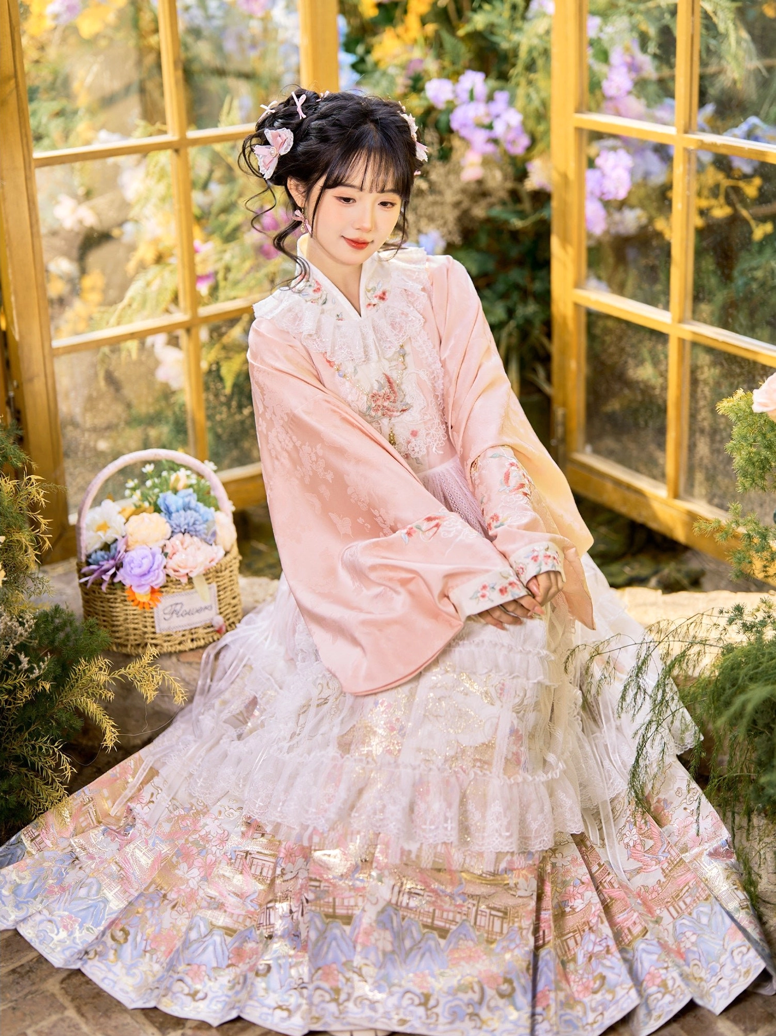Pink and white Ming Dynasty inspired hanfu with layered pipa sleeve top and printed mamianqun skirt in garden setting