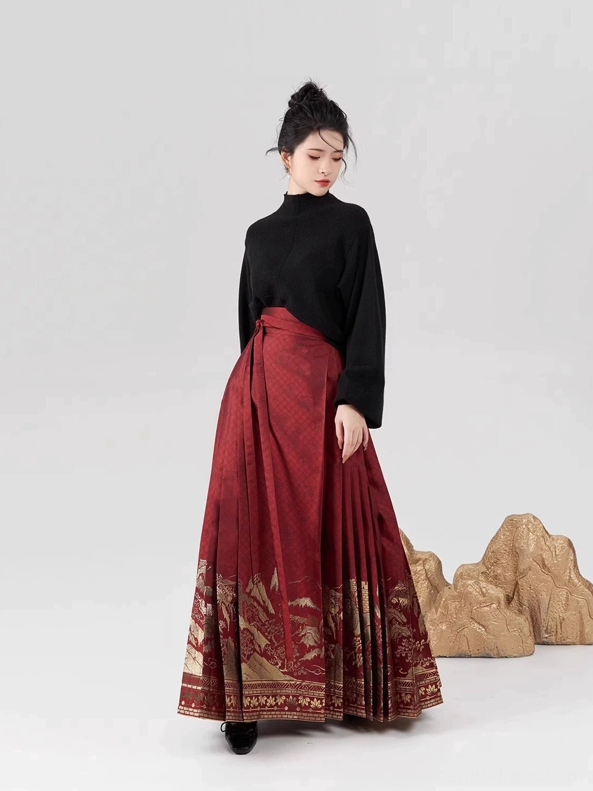 Wine-red pleated Ming Dynasty style mamian skirt with gilt landscape hem paired with black turtleneck modern hanfu styling