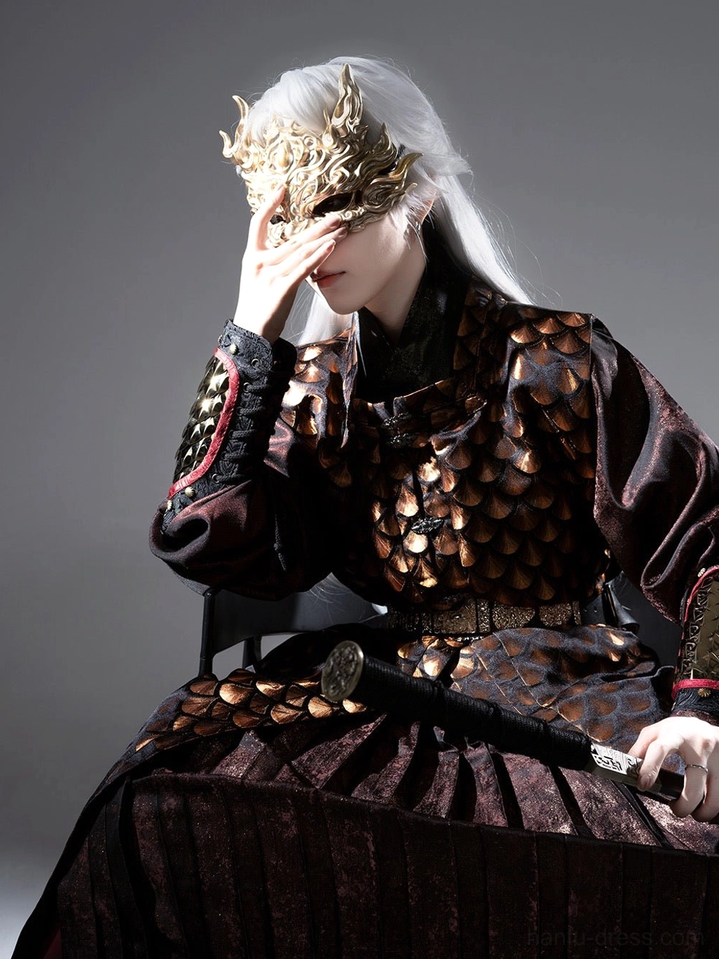 Three quarter upper body view of a Ming Dynasty inspired Tieli Hanfu robe with golden scale pattern white wig golden dragon half mask and sword
