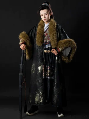 Full front view of a black Ming Dynasty-inspired unisex winter Hanfu coat with scattered gold sprinkle detailing, brown faux fur collar and wide sleeve trims, styled on a model against a dark studio background