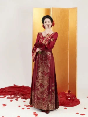 Ming Dynasty wedding Hanfu set in deep crimson with gold dragon motifs and brocade Mamian skirt three quarter front view