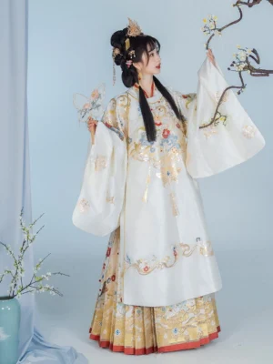Ivory Ming Dynasty wedding Hanfu with gilded floral embroidery, red hem, mamian skirt, and plum branch bridal portrait