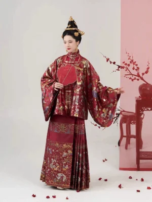 Ming Dynasty wedding Hanfu set in deep red brocade with golden auspicious motifs and Mamian skirt, shown in a three-quarter bridal portrait