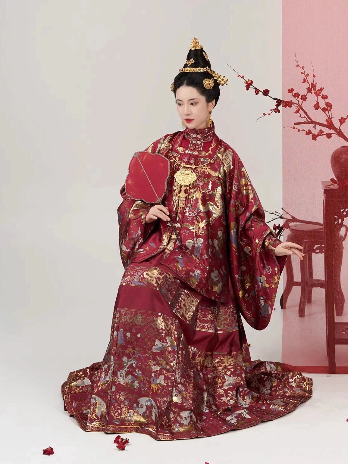 Seated bridal portrait of a Ming Dynasty wedding Hanfu full set with a trailing red brocade Mamian skirt and golden woven motifs