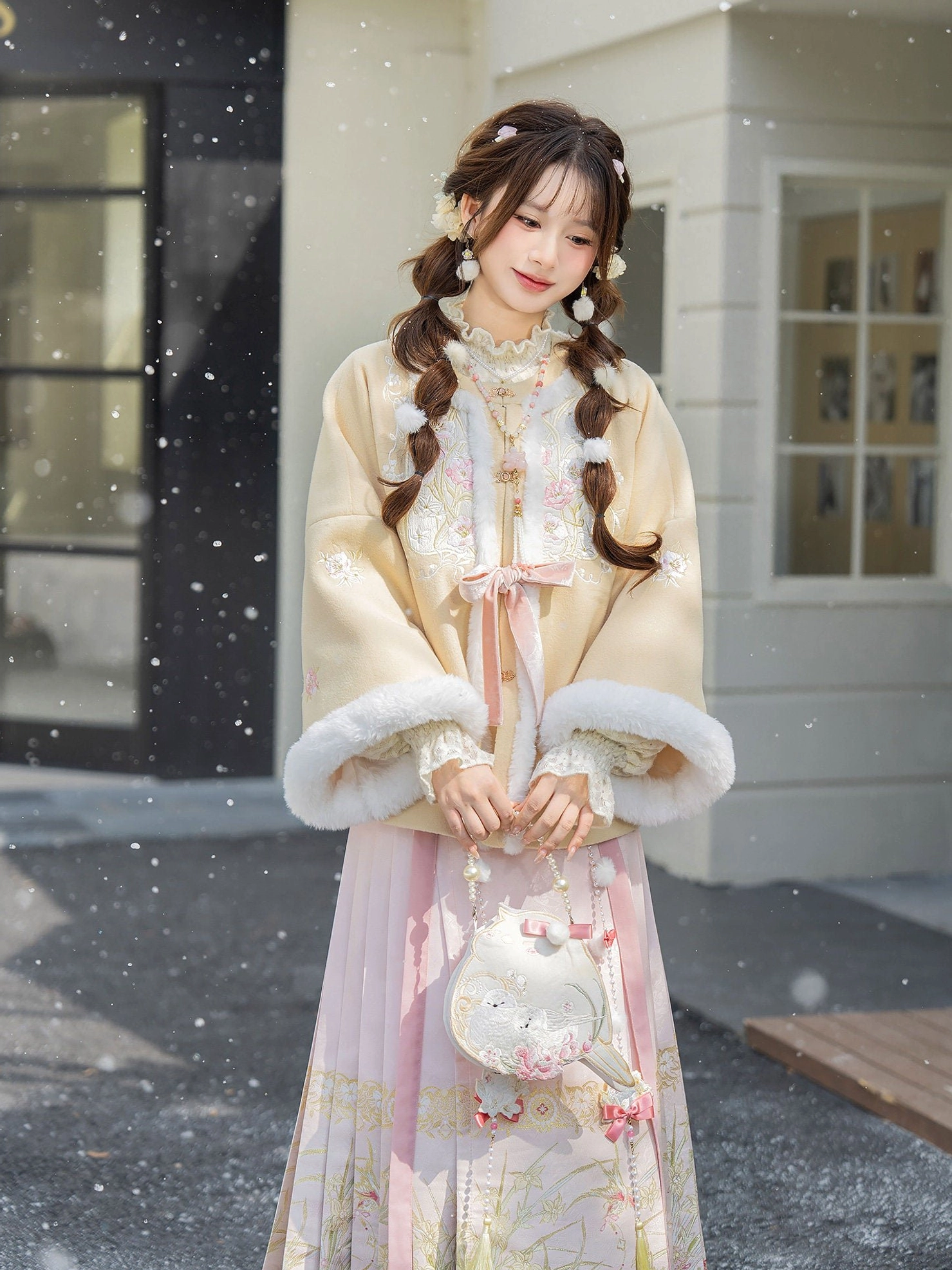 Ming Dynasty winter Hanfu outfit featuring a beige fluffy trim jacket and embroidered pink Mamian skirt styled with a plush crossbody bag