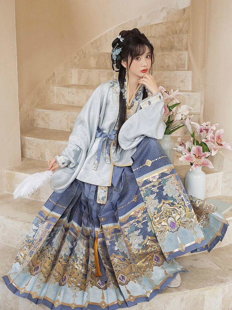 Ming Dynasty women Hanfu full set with flowing pale blue top, gradient dark blue embroidered mamian skirt, tassel waist pendant, and spread skirt pose