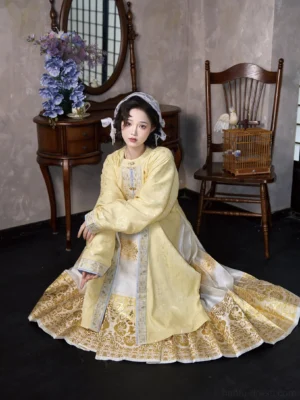 Yellow Ming Dynasty Hanfu round-neck long jacket with wide sleeves and gold brocade horse-face skirt in a side kneeling pose