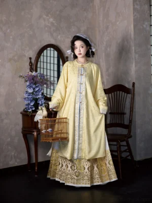 Yellow Ming Dynasty round-neck Hanfu long jacket styled with a gold patterned Mamian skirt in a full-body front view