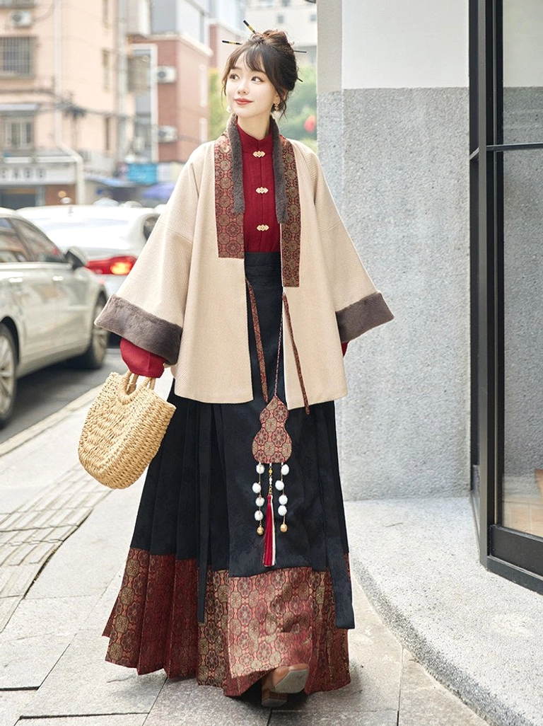 Beige Ming-inspired cross-collar Hanfu jacket with plush cuffs and black red mamianqun horse face skirt outdoor full body view