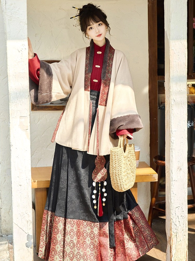 Side view of beige cross-collar Hanfu jacket with patterned trim paired with black and red mamianqun horse face skirt