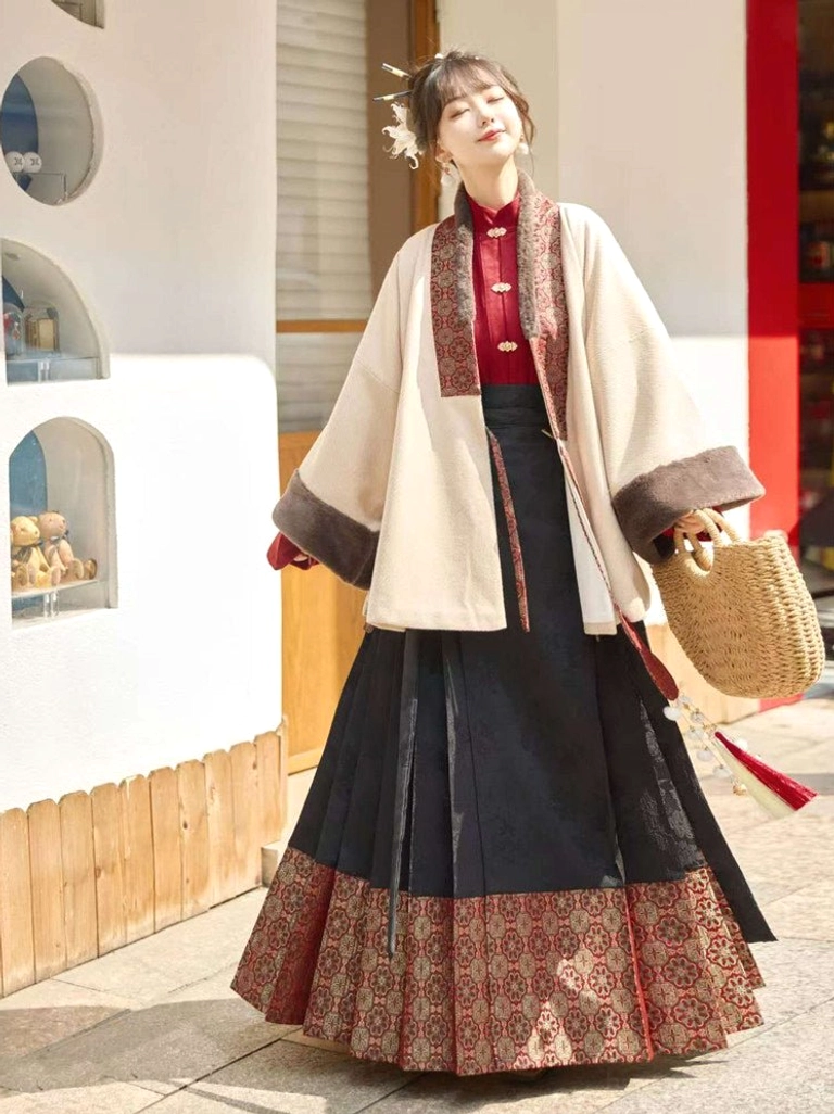 Back side view of beige Ming-inspired Hanfu jacket with plush cuffs and black red mamianqun horse face skirt