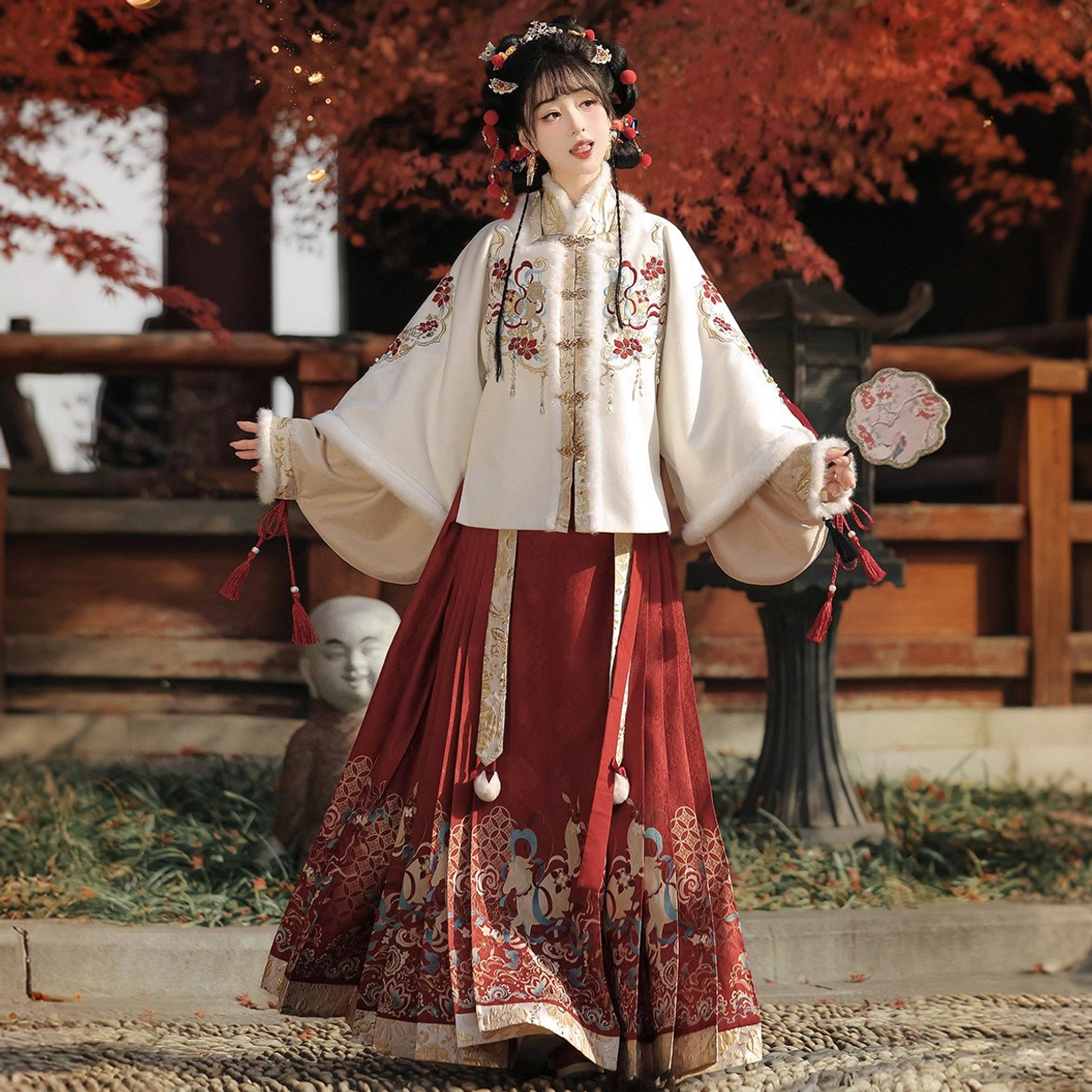 Full Ming-inspired Chinese New Year Hanfu set with embroidered ivory coat red mamian skirt and round silk fan on wooden terrace