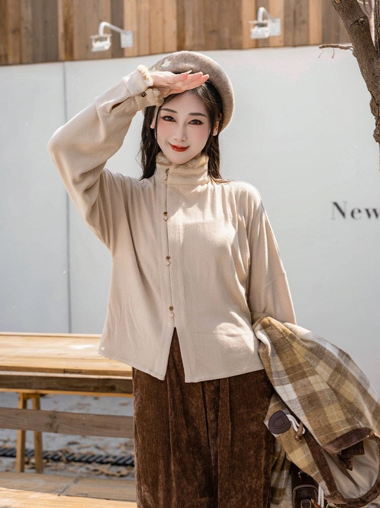 Styling inspiration for Ming inspired Hanfu outfit with beige high neck top and brown corduroy wide leg pants outdoors
