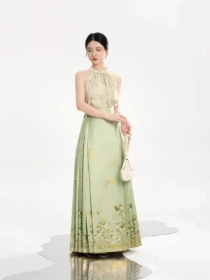 Modern Ming-inspired Hanfu outfit with a beige-green satin halter top and light green floral Mamian skirt shown on a model
