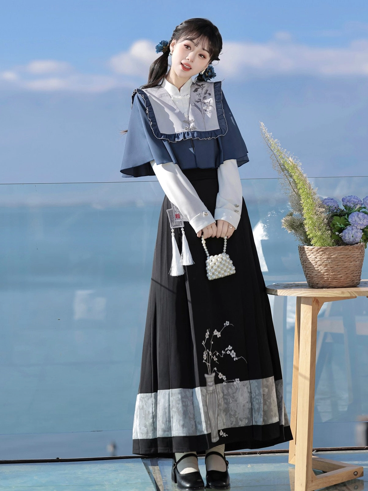 Three-quarter view of Ming Dynasty inspired Hanfu shawl blouse and black mamianqun horse face skirt with waist tassel