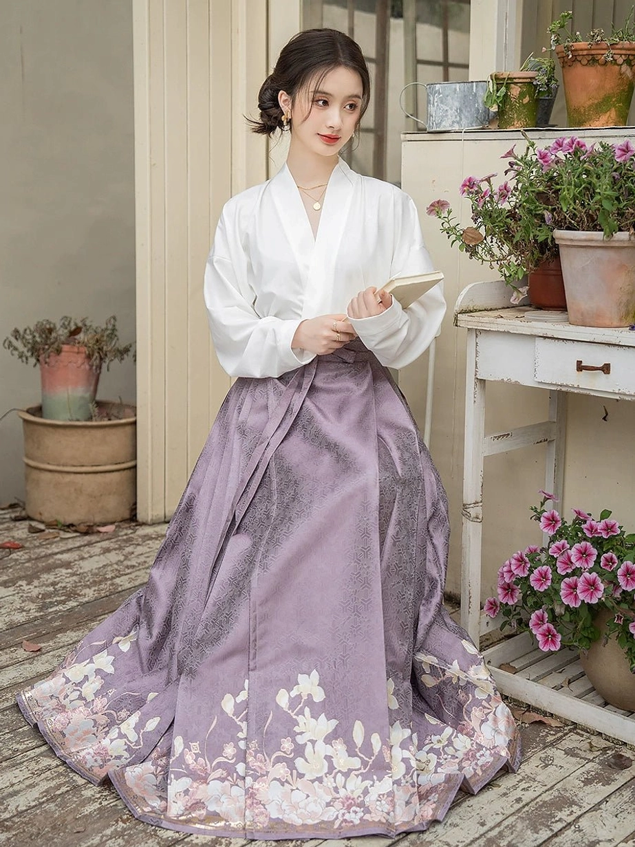 Full side view of a Ming-inspired Hanfu two-piece outfit with an elegant white cross-collar blouse and floor-length dusty purple mamianqun horse face skirt covered with floral hem details