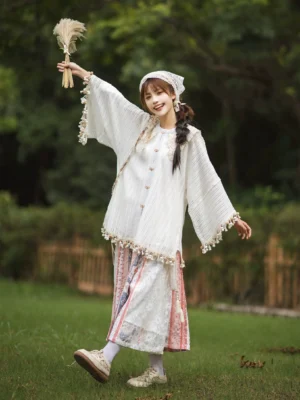 Full body outdoor view of Ming-inspired modern Hanfu blouse and printed wrap skirt outfit with tassel trim