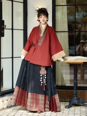 Red Ming-inspired cross-collar Hanfu jacket and black mamianqun horse face skirt full set front view indoors