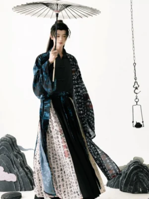 Full body front view of a male Ming inspired Taoist Hanfu outfit in black with ancient calligraphy prints, blue bamboo accents, flowing sleeves, and a traditional Chinese topknot