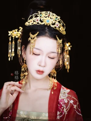 Ming Dynasty inspired phoenix Hanfu wedding hair accessories worn with red embroidered Hanfu, showing symmetrical side ornaments and dangling pearl tassels