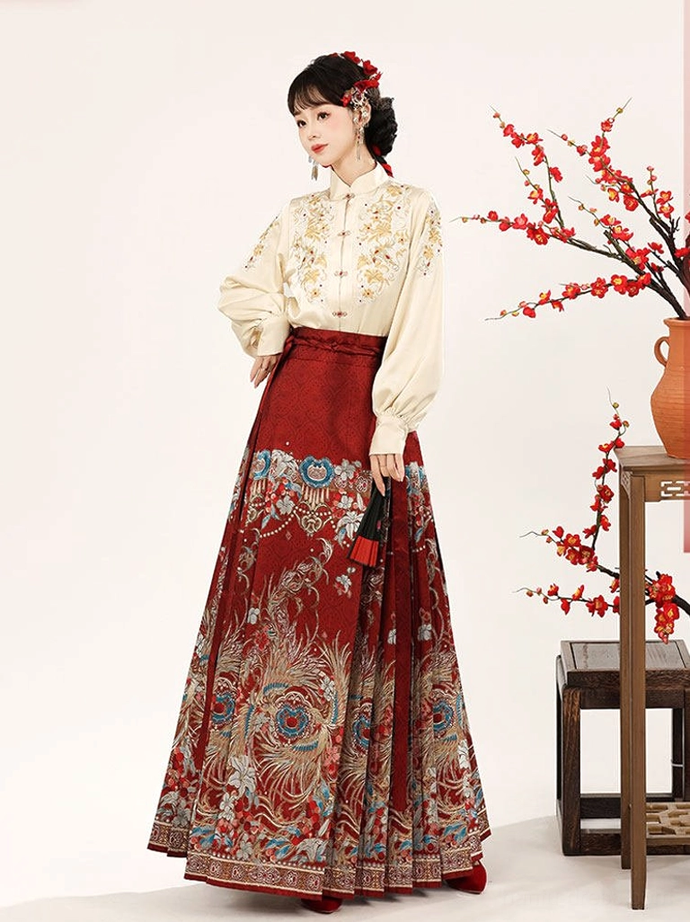 Ming-style beige Hanfu blouse with golden floral embroidery paired with a flowing red mamian skirt three-quarter view