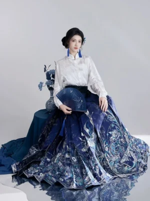 Ming style blue landscape mamian skirt Hanfu outfit with white stand collar top shown in seated three quarter view