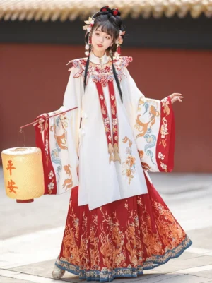 Ming-style Chinese bridal Hanfu outfit with white embroidered robe, red printed mamianqun horse-face skirt, and matching cloud collar in a traditional courtyard