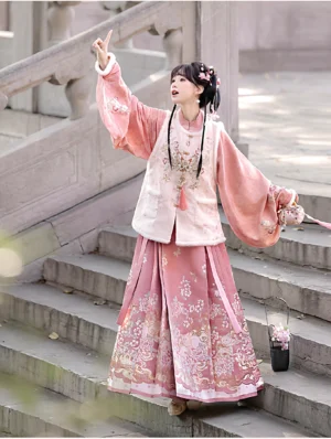 Ming style Chinese New Year Hanfu outfit featuring a blush pink lantern sleeve top off white fuzzy embroidered vest and flowing skirt
