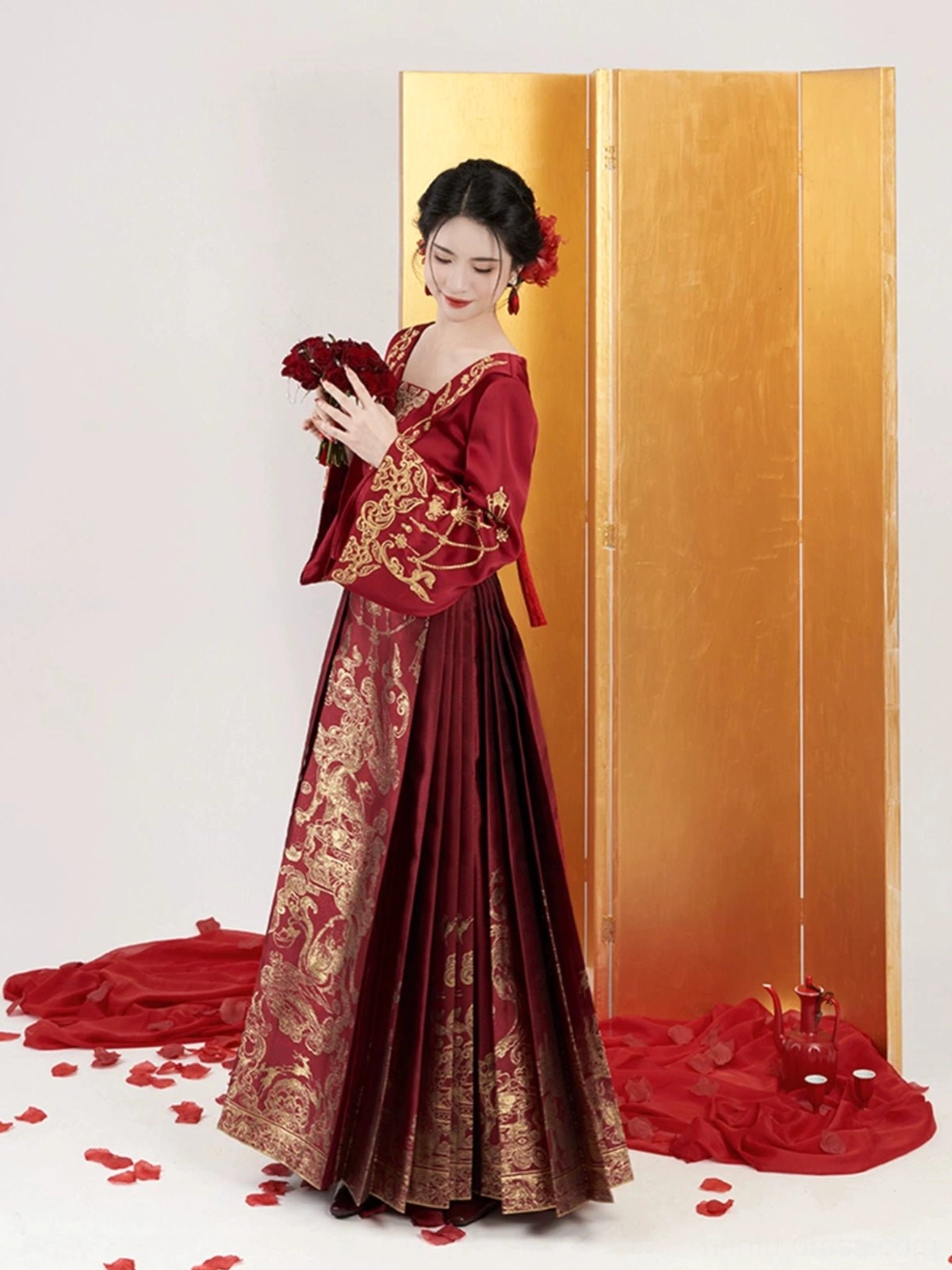 Side view of Ming style Chinese wedding Hanfu with flowing red brocade Mamian skirt and gold auspicious patterns