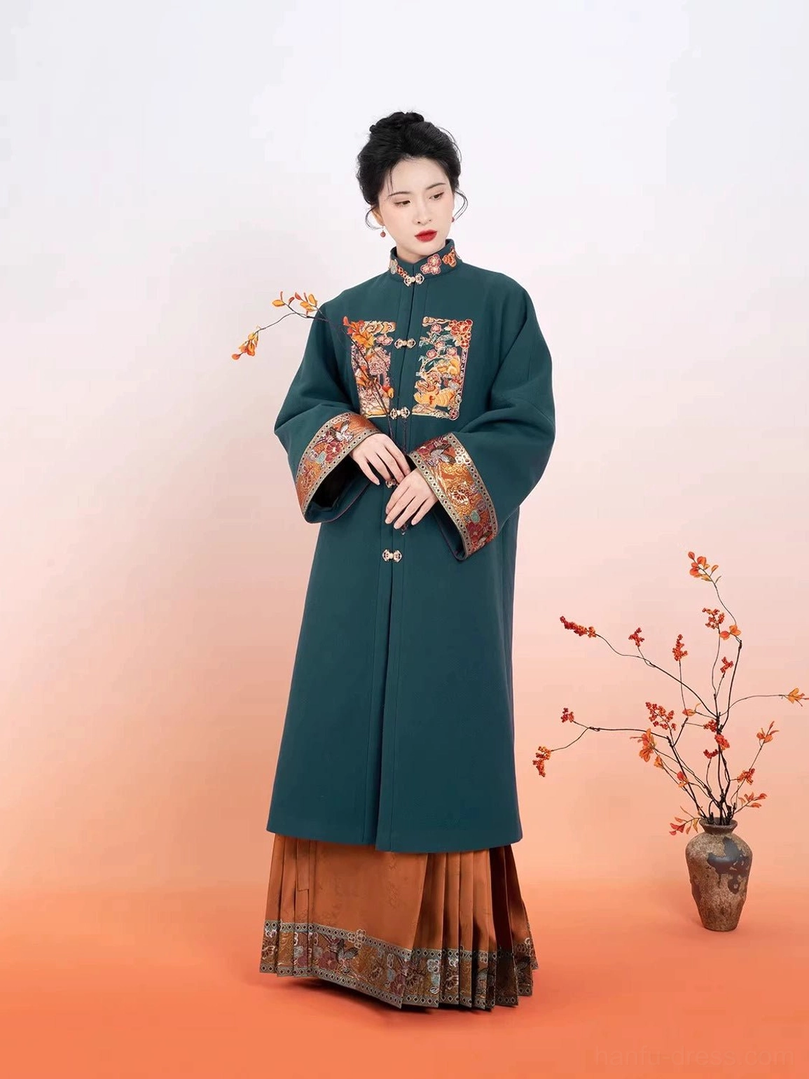 Side-front view of a Ming-style Hanfu ensemble showing the pleated horse-face mamianqun skirt and decorative brocade hem trim