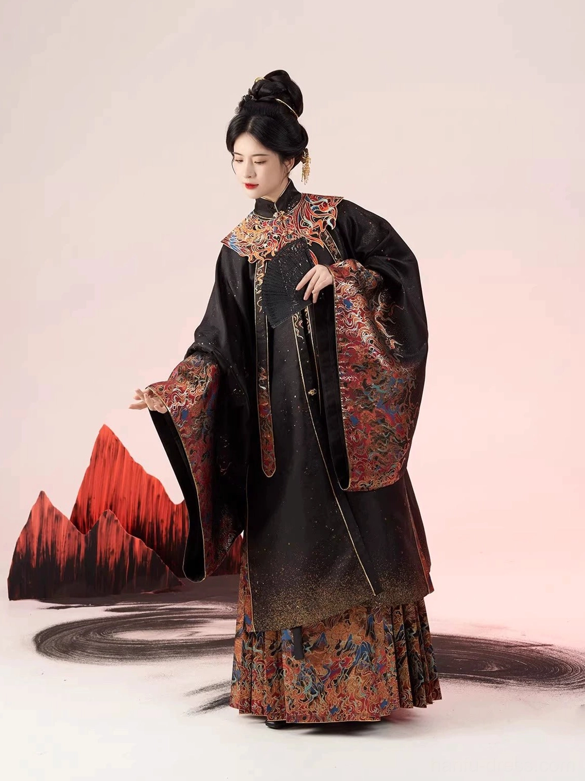 Side view of a fitted standing-collar Ming-style Hanfu outfit with wide sleeves, patterned mamian skirt hem, and traditional handheld fan
