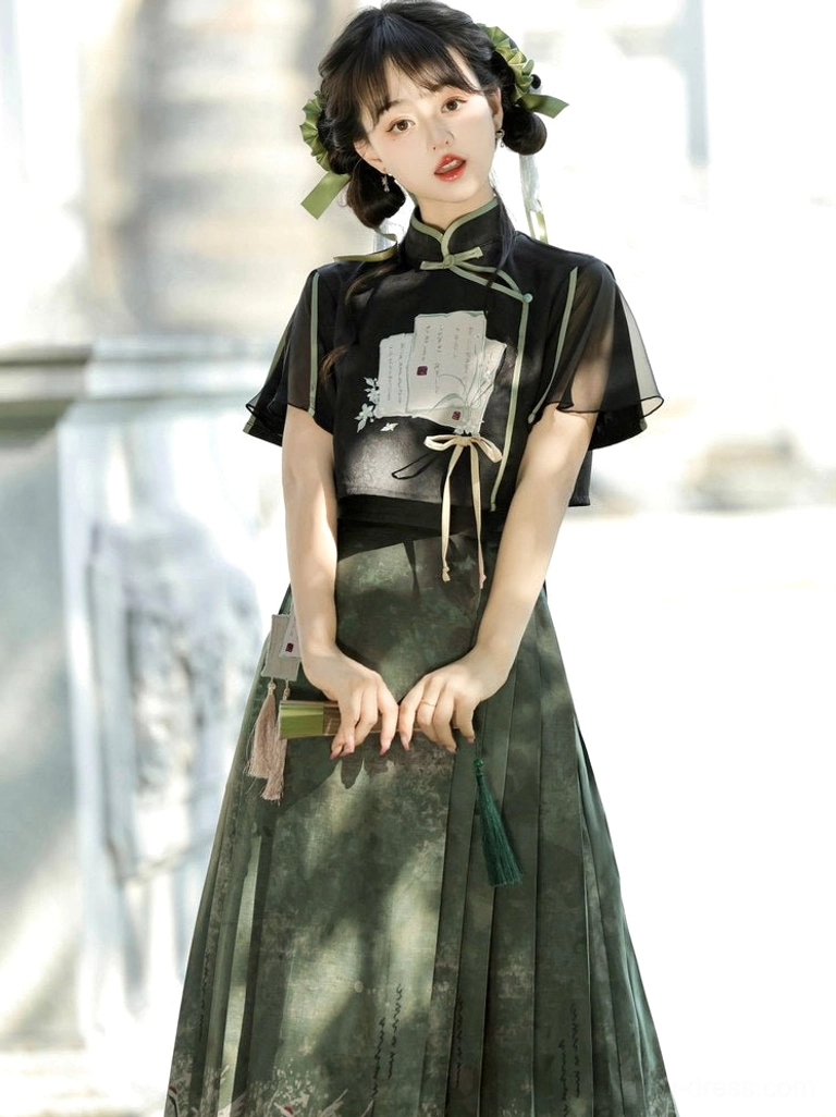 Ming-style Hanfu cropped stand-collar top paired with a high-waisted green mamianqun skirt and waist tie details