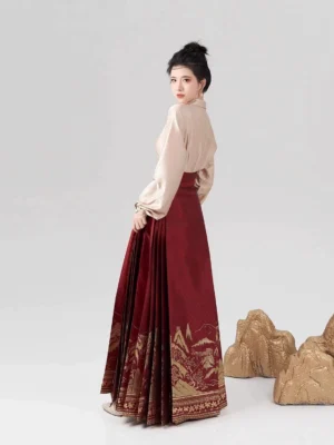 Back three-quarter view of Ming style modern hanfu set with champagne blouse and wine-red pleated mamian skirt for Lunar New Year