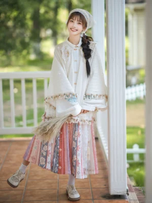 Ming style modern Hanfu stand collar blouse and pleated wrap skirt worn with a headscarf in a garden setting